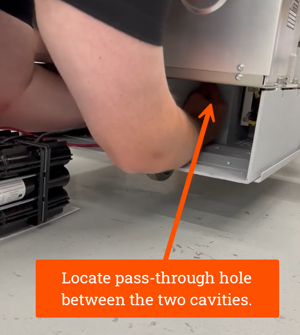 Locate pass-through hole between the two cavities