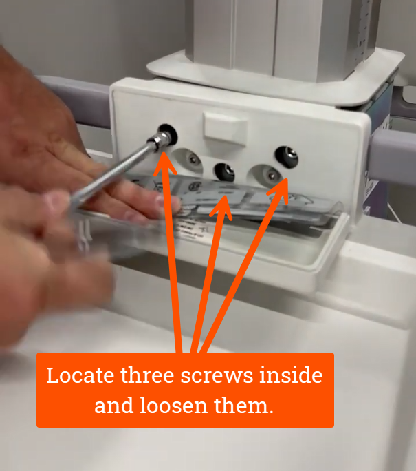 Locate three screws inside and loosen them