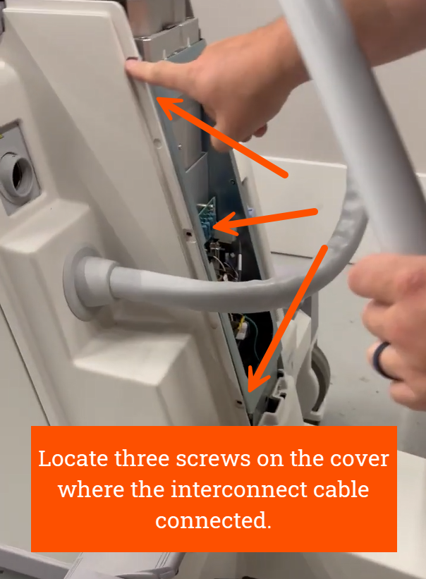 Locate three screws on the cover where the interconnect cable connected