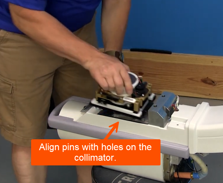 align pins with holes on the collimator